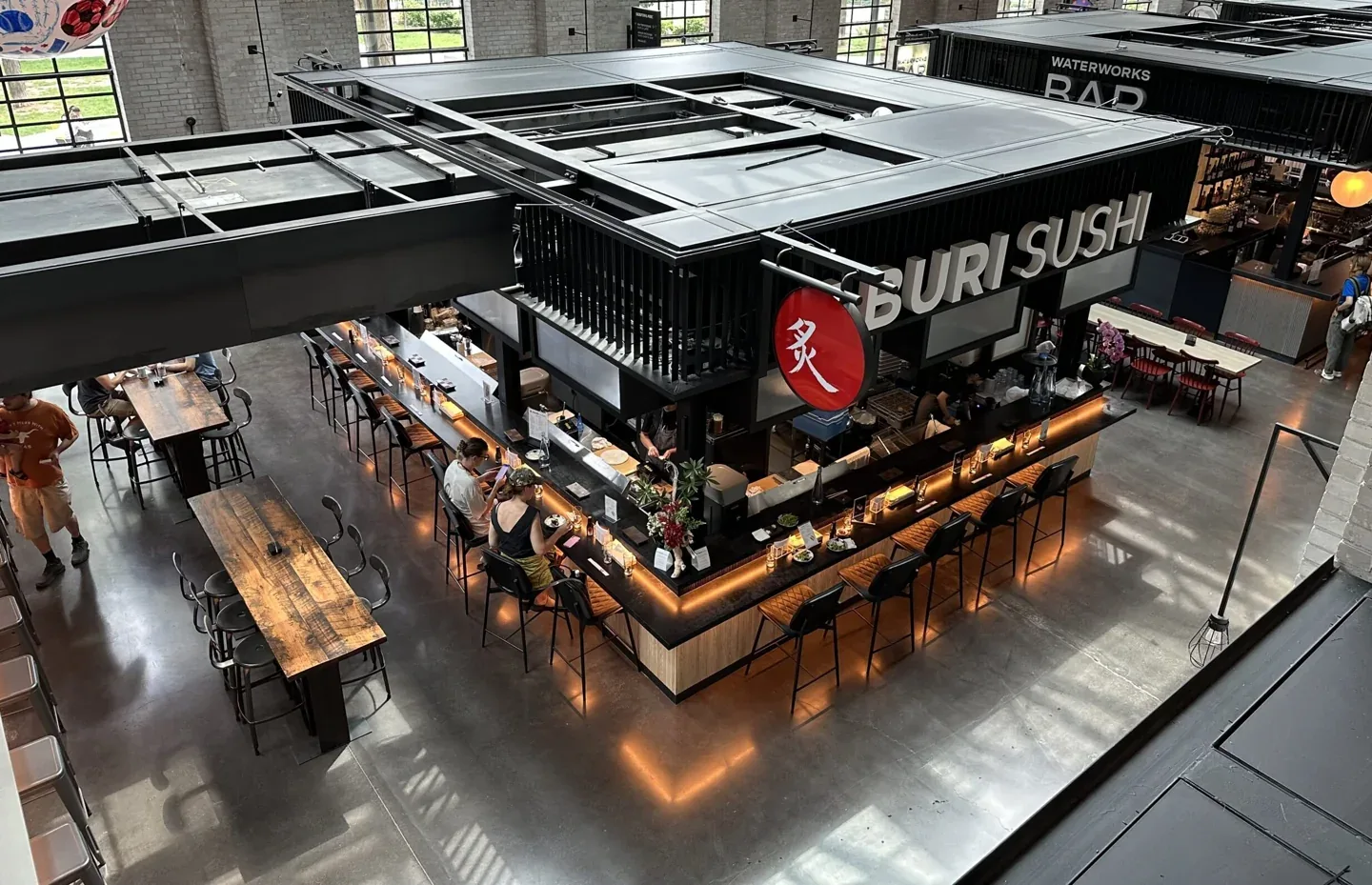 An overhead view of food stalls below the skylights at Waterworks