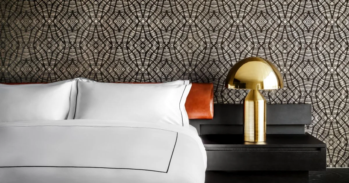 White pillows against a patterned headboard in a Bisha hotel room