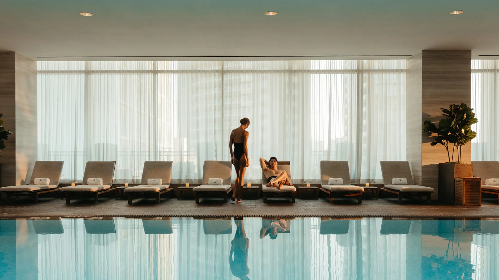 Guests relax beside the indoor pool at Four Seasons Hotel Toronto