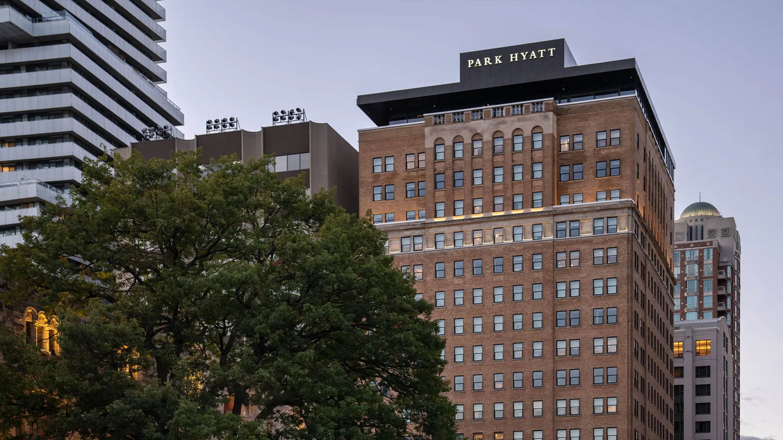 Park Hyatt Toronto on Avenue Road with trees along the street