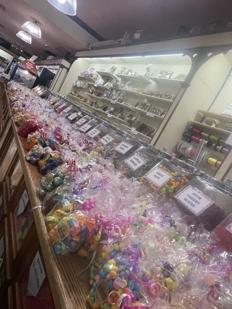 Candy jars and wrapped sweets along a counter at Nutty Chocolatier