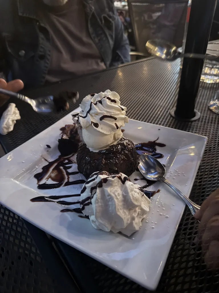 A chocolate dessert with whipped cream at Outrigger