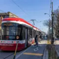 TTC streetcar stopped beside traffic on a Toronto street