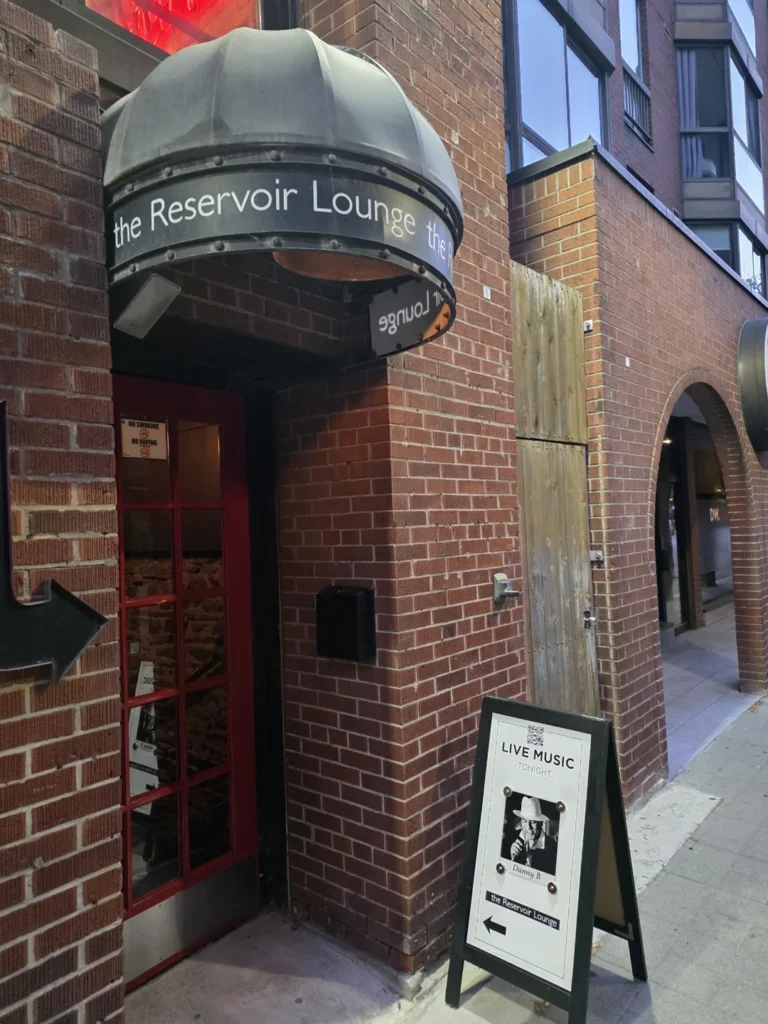 The red doorway and curved Reservoir Lounge sign on Wellington Street East