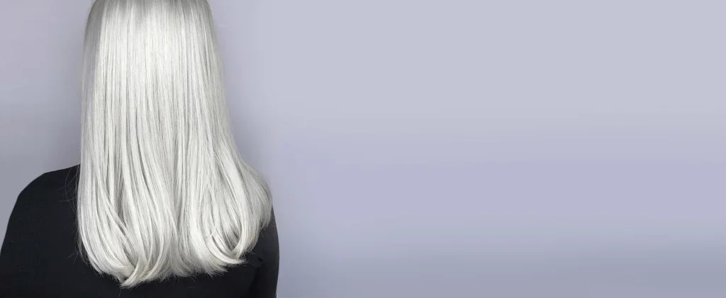 Silver hair with softly curled ends shown on The Cabinet’s website.