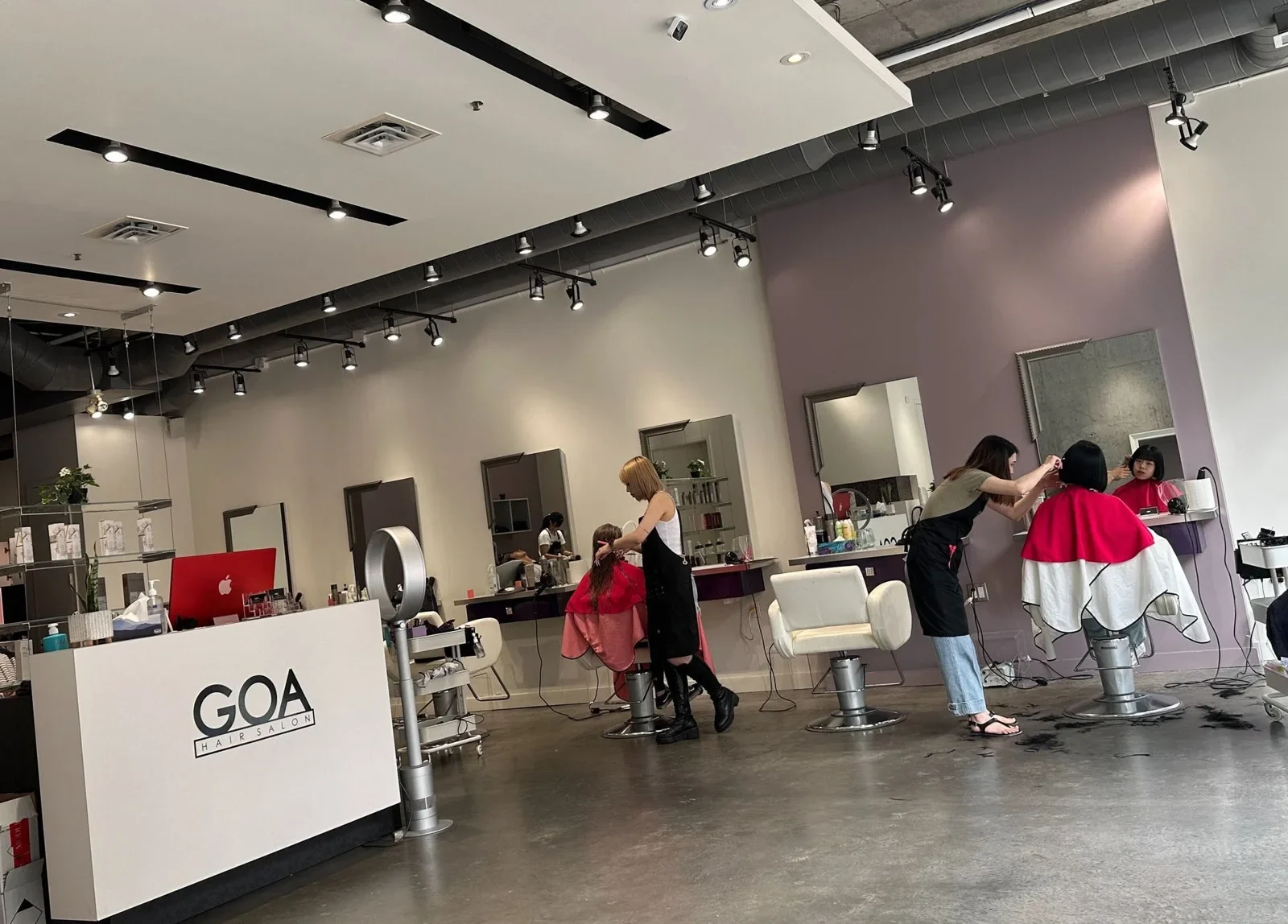 People at the front desk of GOA Richmond.