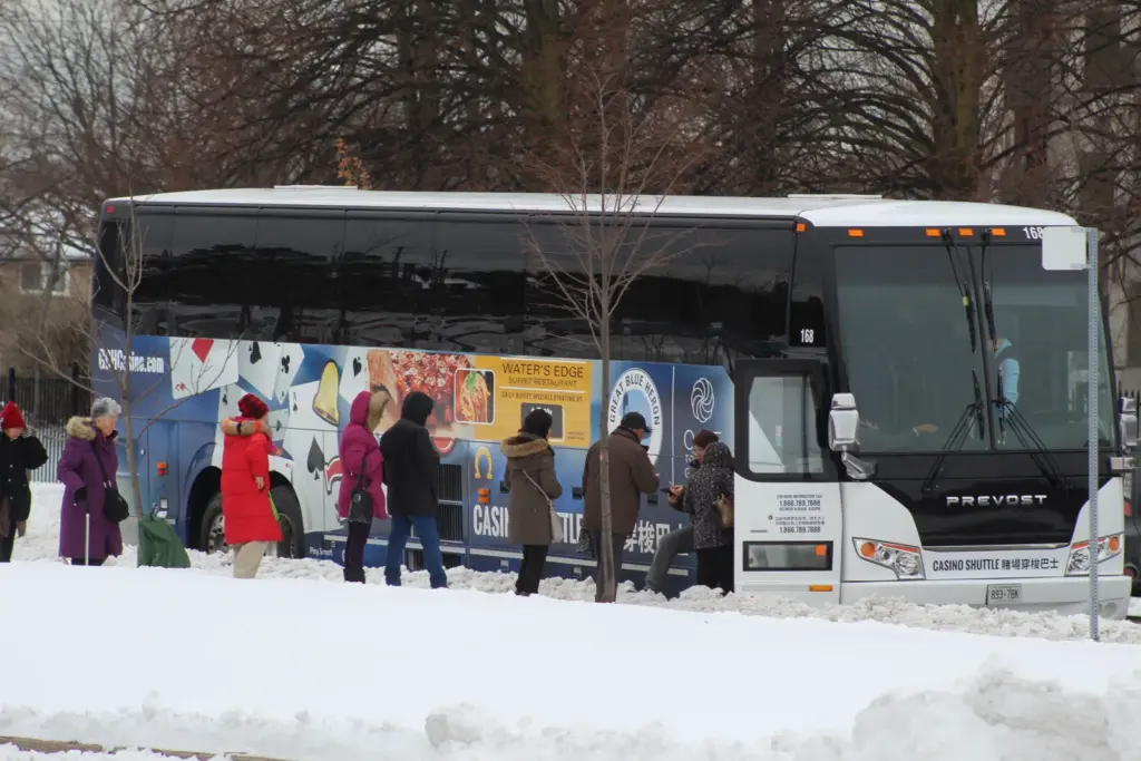 People boarding a bus outside Woodside Square in Scarborough during winter