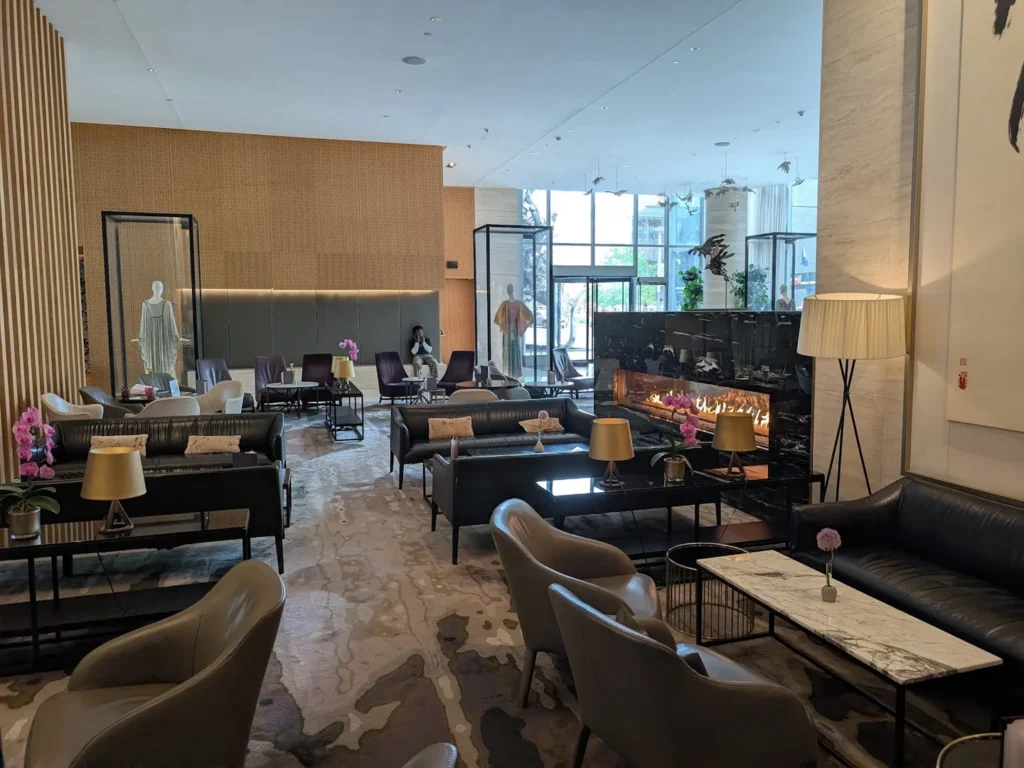 Sofas, lounge chairs, a fireplace and tall windows at Shangri-La Toronto