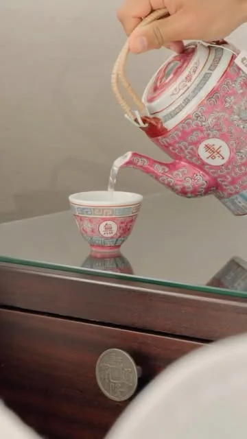 Tea poured from a pink floral teapot into a matching cup at Shangri-La Toronto