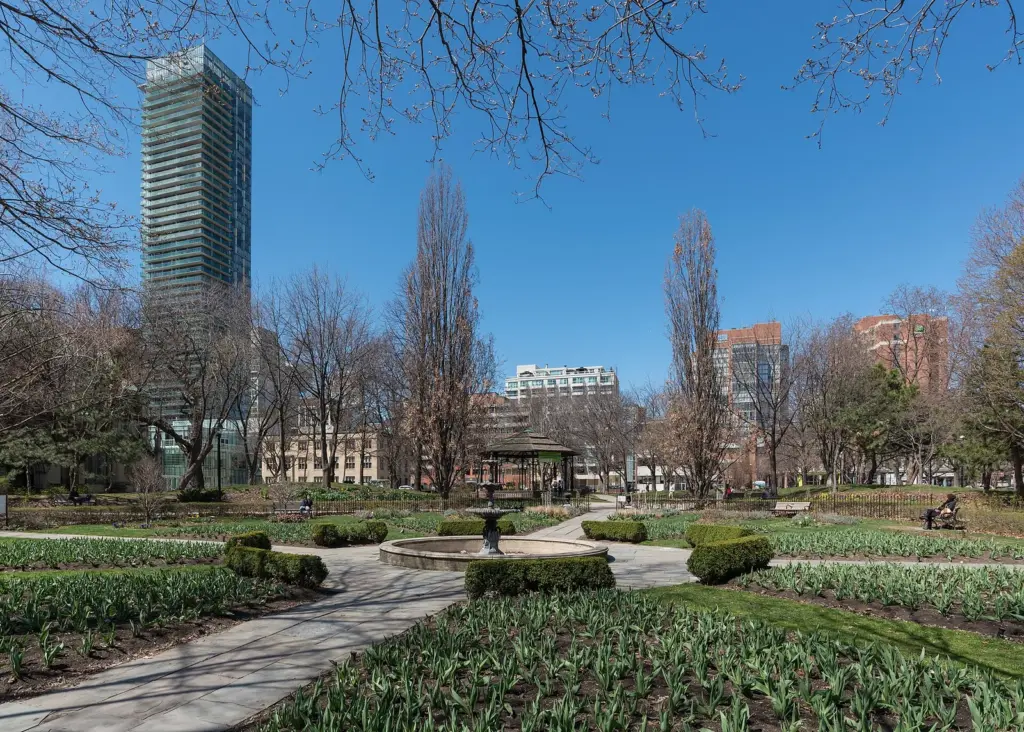 Downtown towers rising around the trees and lawn of St. James Park
