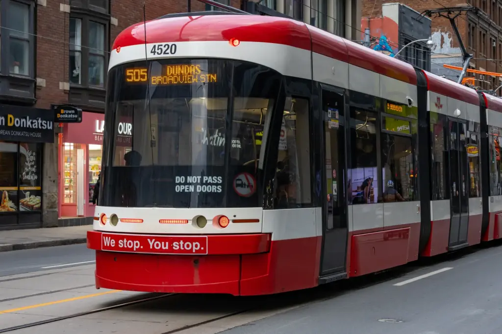 TTC streetcar displaying a We Stop You Stop safety message in Toronto