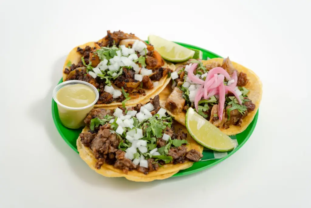 Four vegan tacos with lime and pickled onions from Taqueria Vegana in Toronto