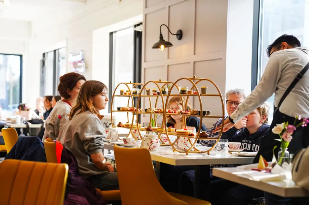 Guests seated with tiered high tea trays at Tiarre's in Toronto