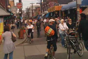 People walking through a car-free Kensington Market street in Toronto