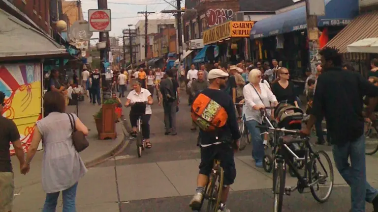 People walking through a car-free Kensington Market street in Toronto