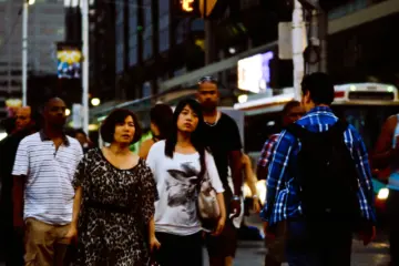 Large crowd crossing at Yonge and Dundas in downtown Toronto
