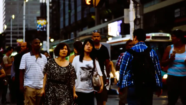 Large crowd crossing at Yonge and Dundas in downtown Toronto