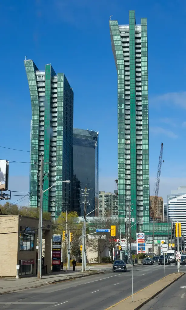 Tall residential tower rising above a Toronto street