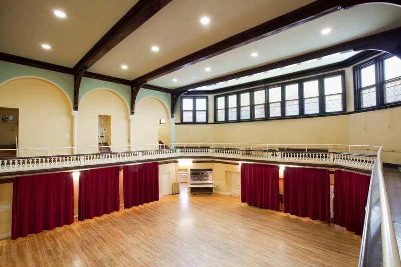 Wood floor and high windows in the gym at Trinity-St. Paul’s Centre