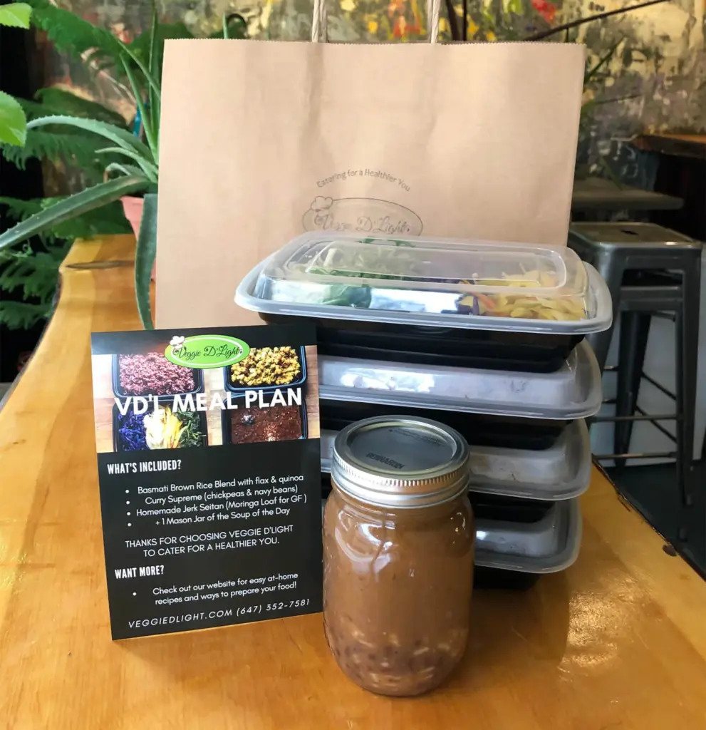 Prepared vegan Caribbean meal containers from Veggie D'Light in Kensington Market