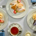 Plates of small sandwiches, pastries and tea at the Omni King Edward Hotel