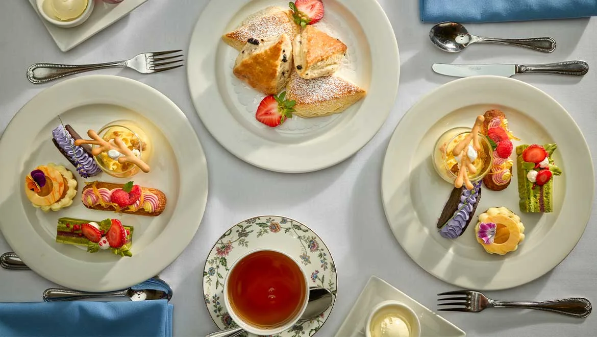 Plates of small sandwiches, pastries and tea at the Omni King Edward Hotel