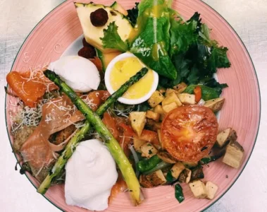 Eggs Benedict with potatoes and greens at ViVetha Bistro