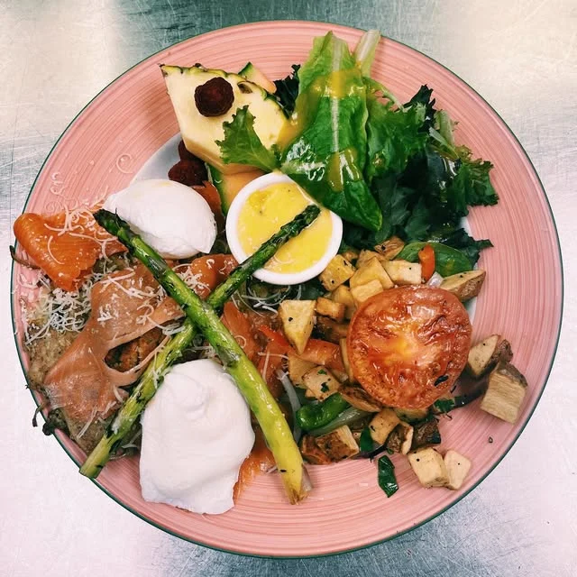 Eggs Benedict with potatoes and greens at ViVetha Bistro