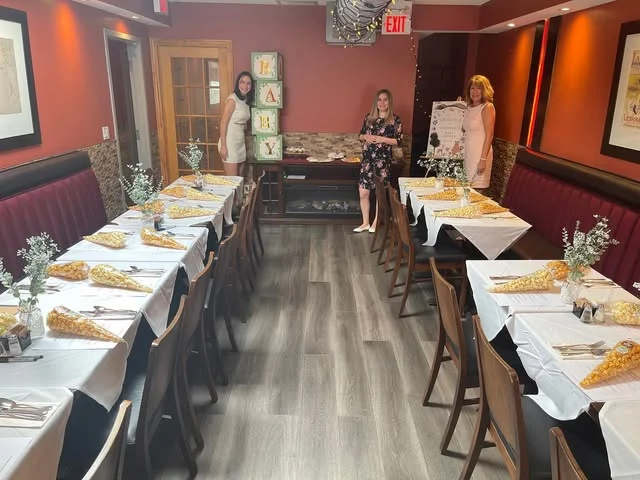 Set tables and red banquettes in ViVetha Bistro's dining room