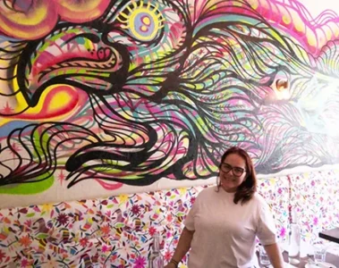 XOLA owner Malinali Fernandez beside the colourful eagle mural