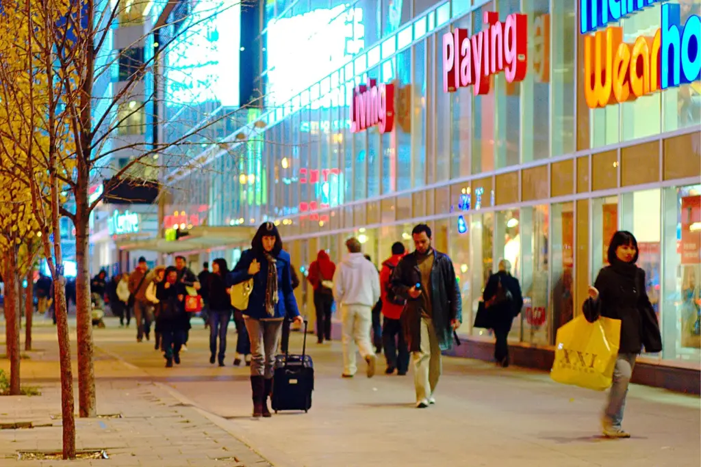 Pedestrians walking beside shops on Yonge Street in Toronto