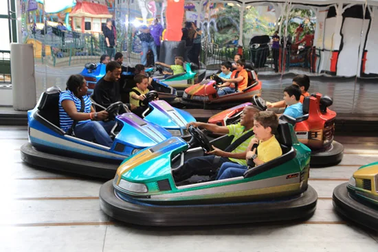 Children and adults riding bumper cars at Fantasy Fair