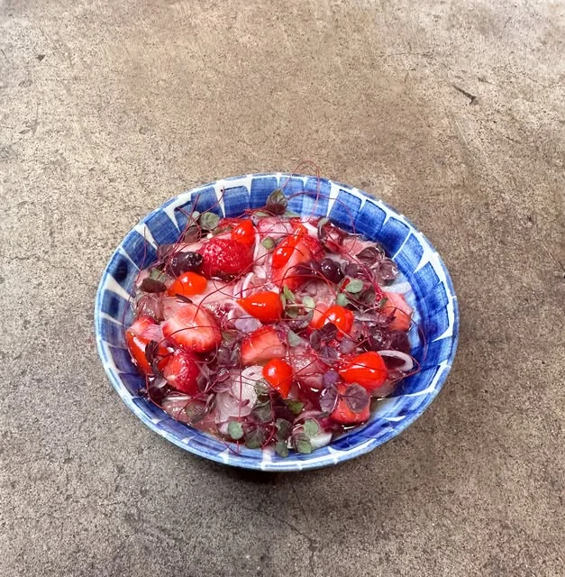 A plated dish with red berries at Lake Inez