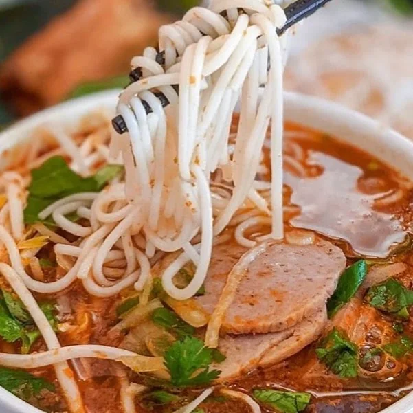 Noodles lifted from a bowl of soup at Pho Ngoc Yen
