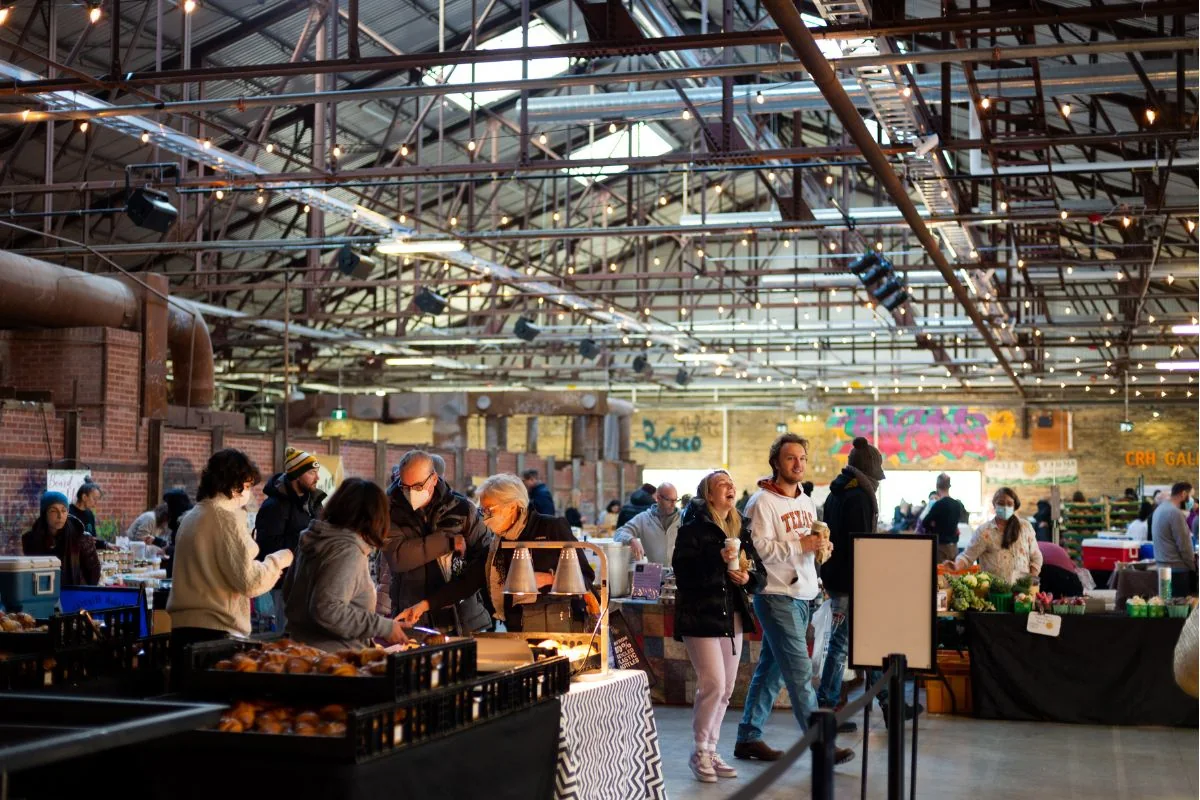 Shoppers at the indoor farmers market at Evergreen Brick Works