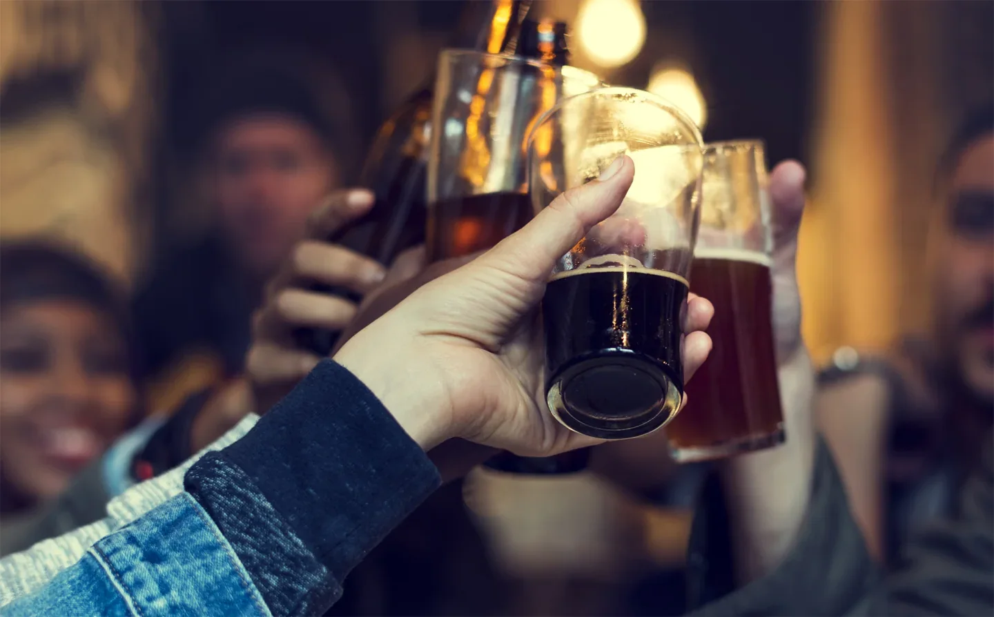 Hands raising beer glasses in a pub photograph supplied by The Rhino