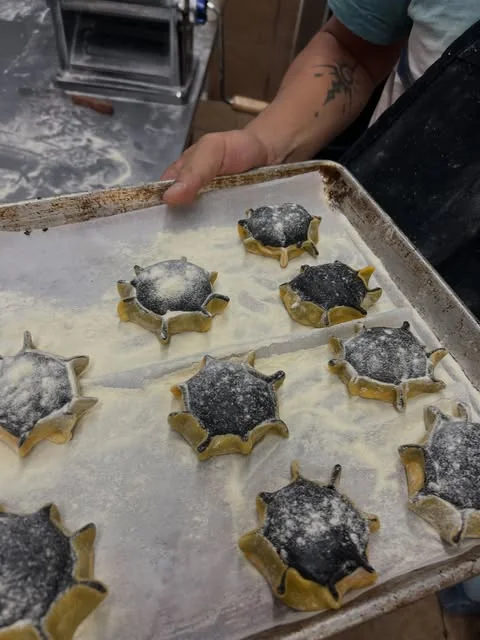 A cook preparing filled pasta at Lake Inez
