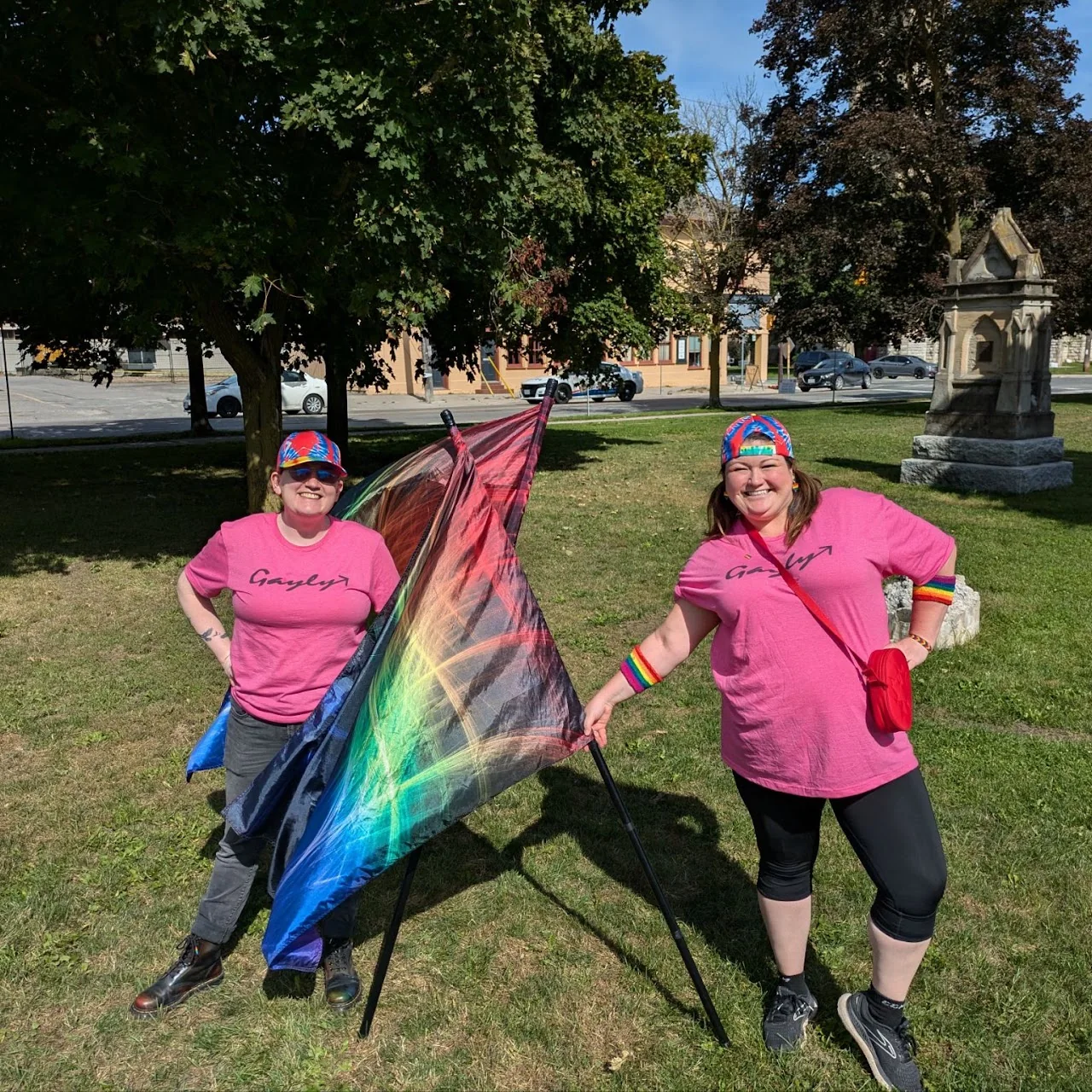 Gayly Forward colour guard members holding rainbow flags