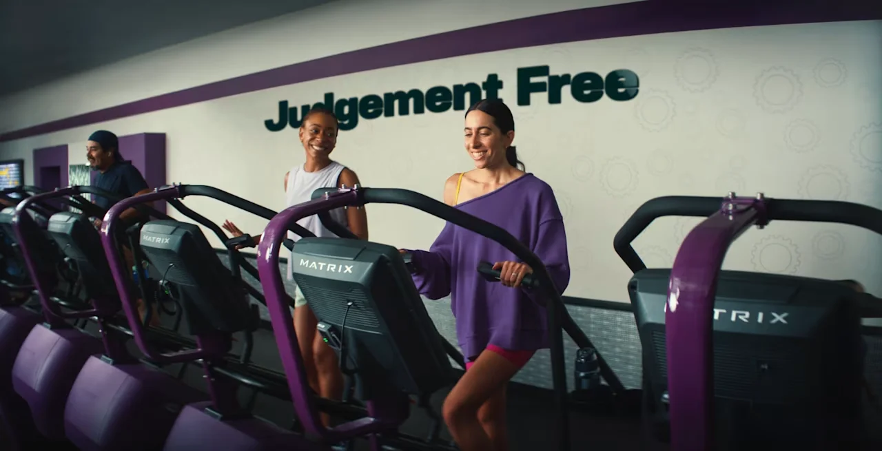 Women walking on treadmills in a Planet Fitness gym