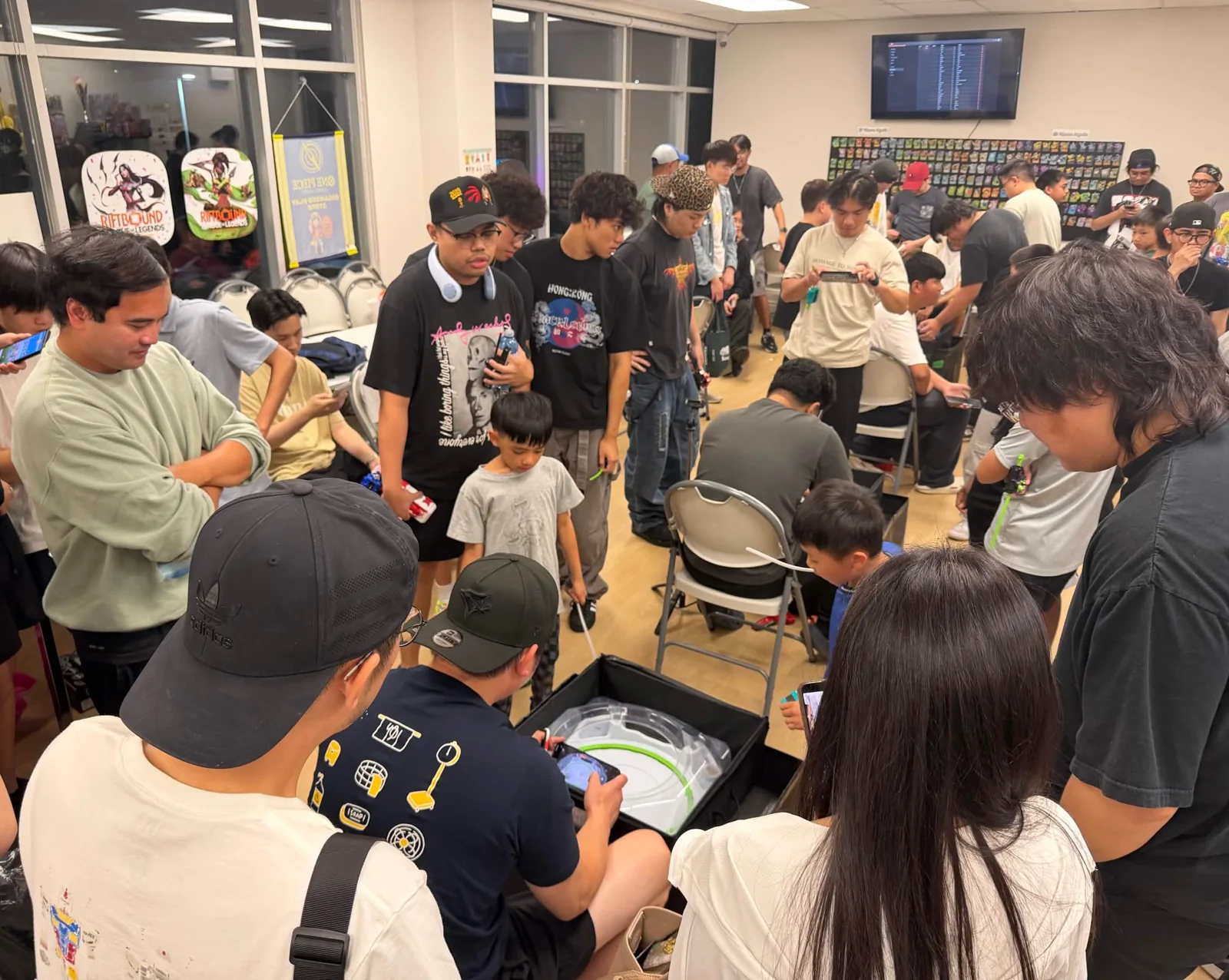 Players gathered around Beyblade stadiums at Claw Me Baby Games in Markham