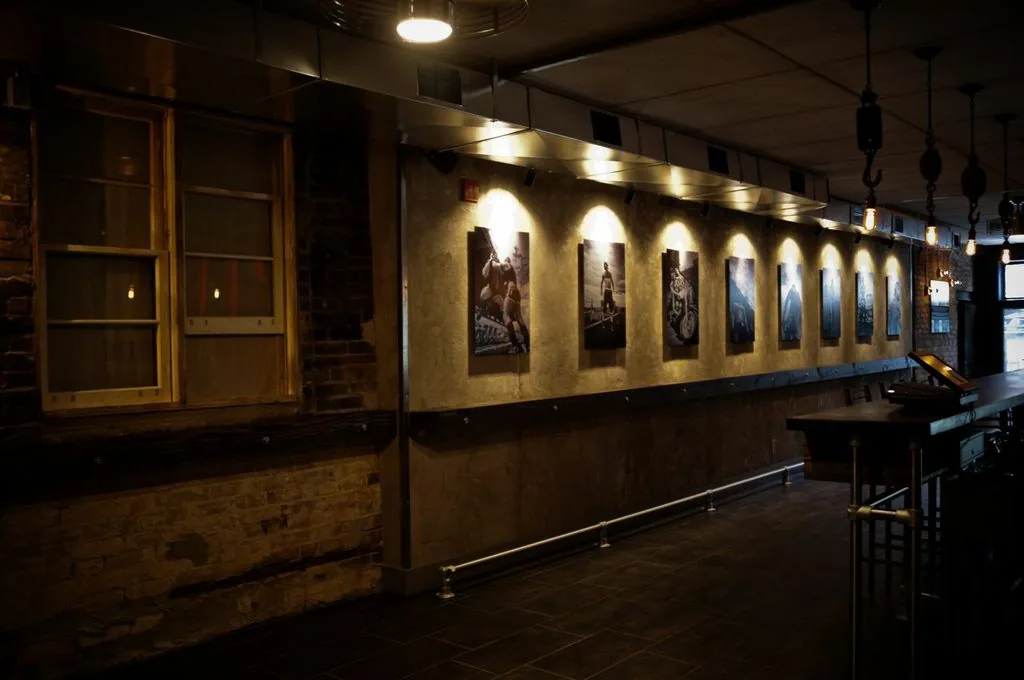 Black Eagle bar interior with photographs displayed along the wall