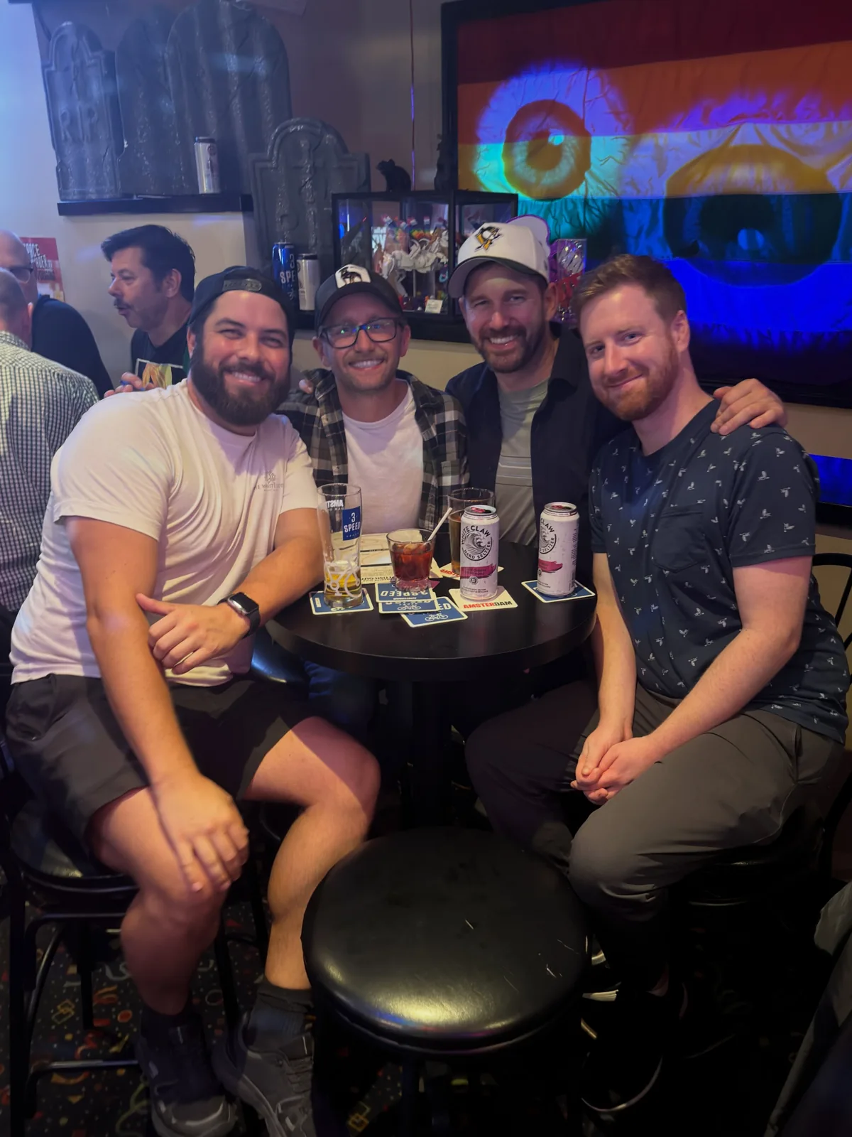 Four people sitting at a table with drinks inside Pegasus
