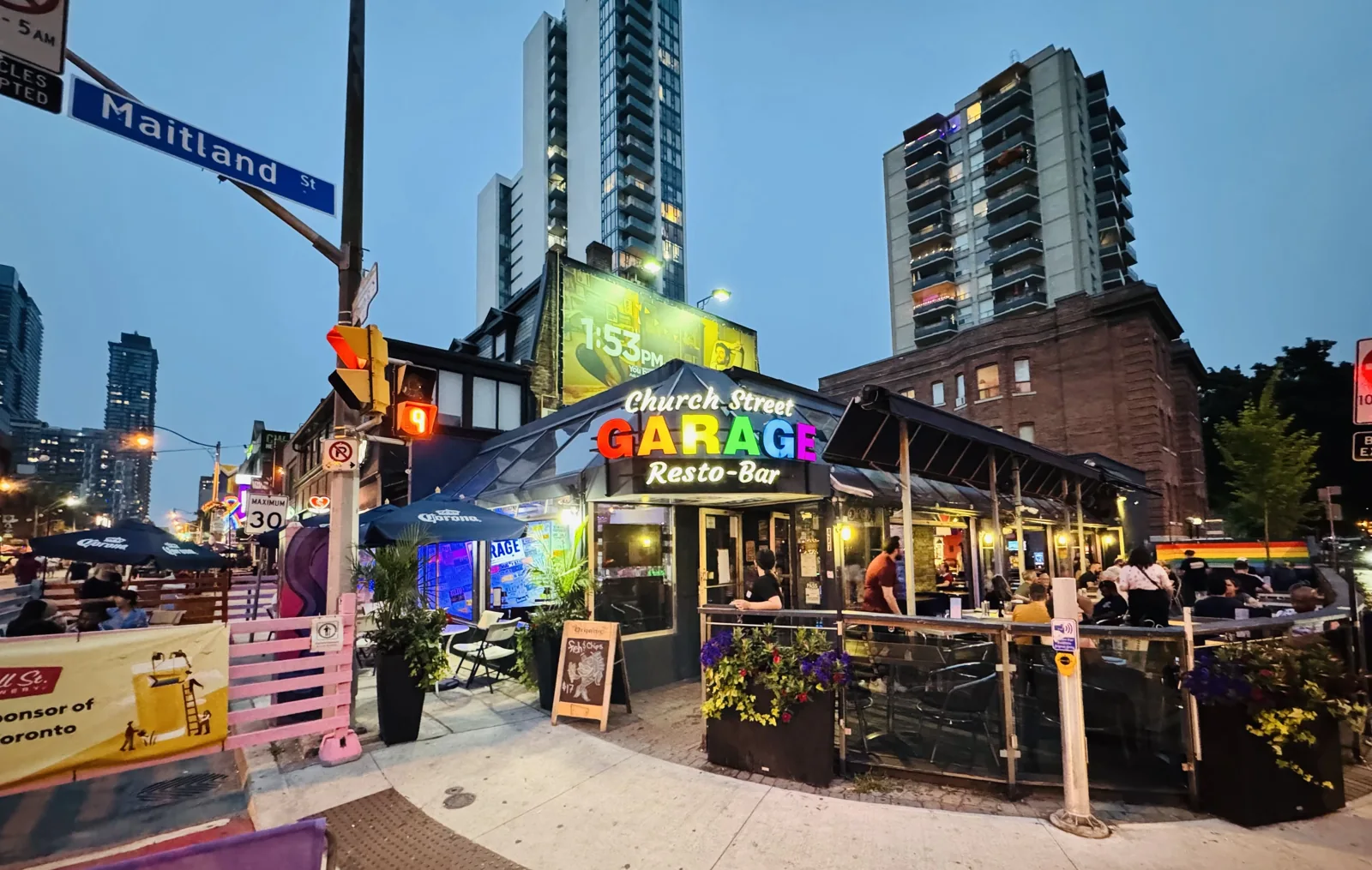 Church St. Garage’s patio and storefront at Church and Maitland at dusk