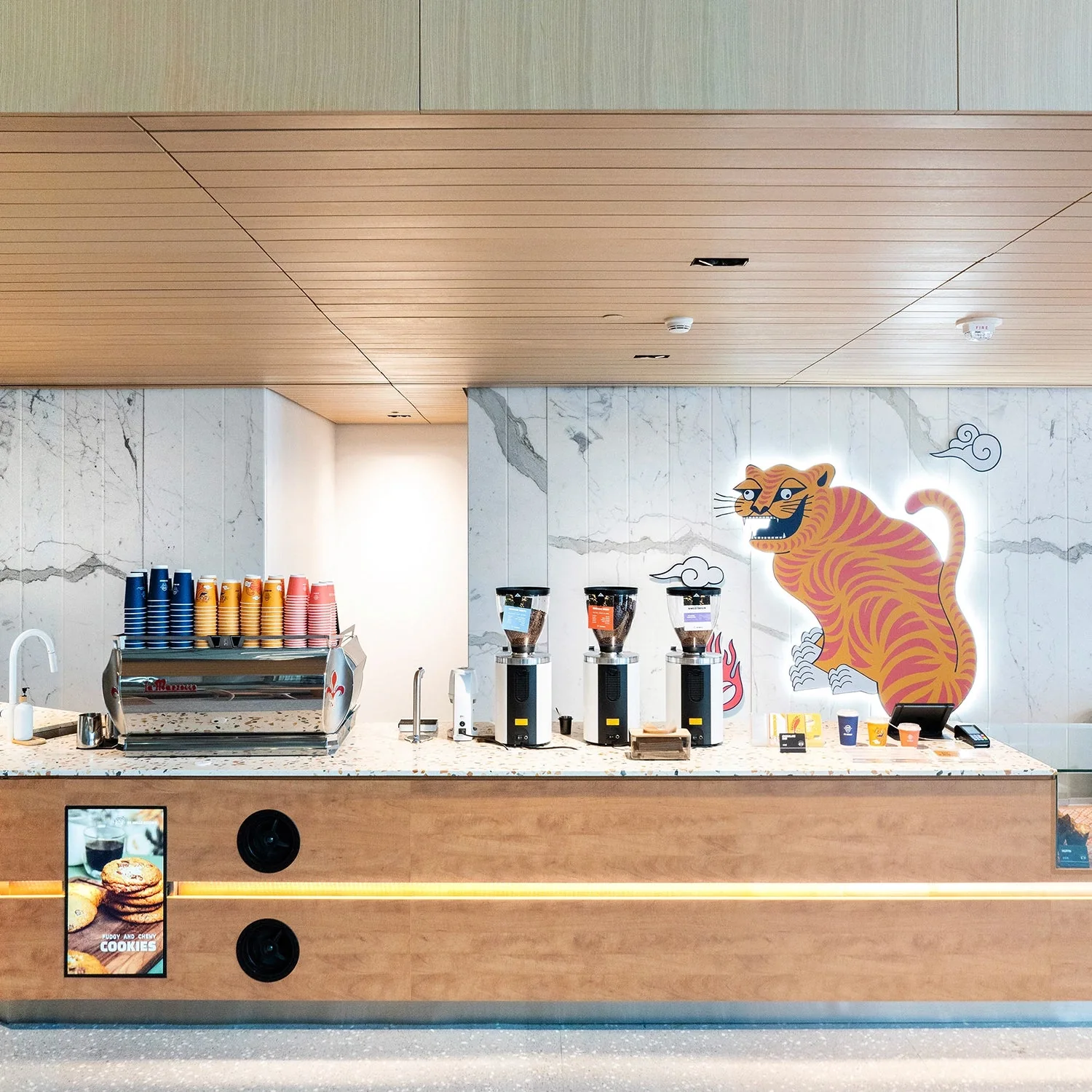 Coffee kiosk with a colourful mural at De Mello in The Well