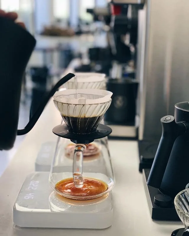 Coffee being brewed through paper filters into a carafe at Hatch