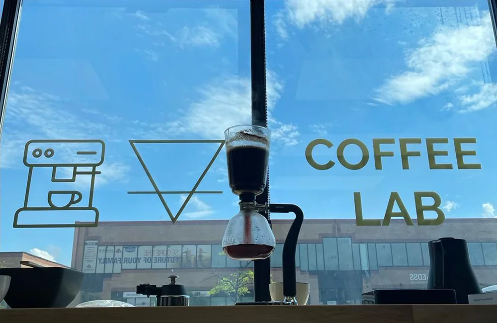 A coffee brewer on a counter beside the window at Pirates of Coffee’s lab