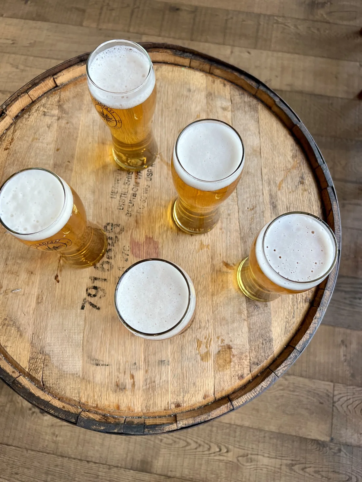Glasses of beer on a wooden barrel at Steadfast Brewing