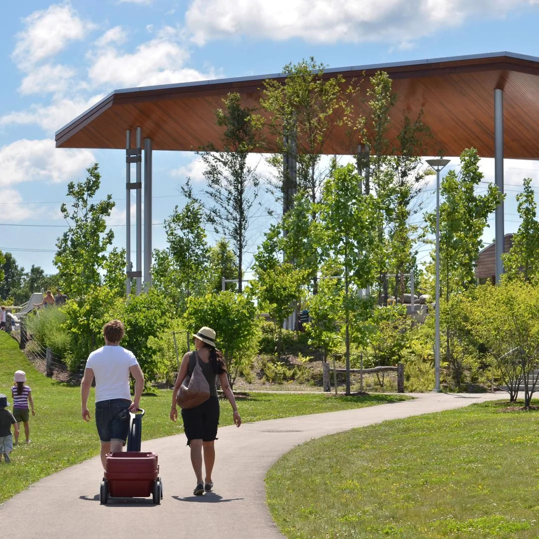 Visitors walk on park paths at Corktown Common