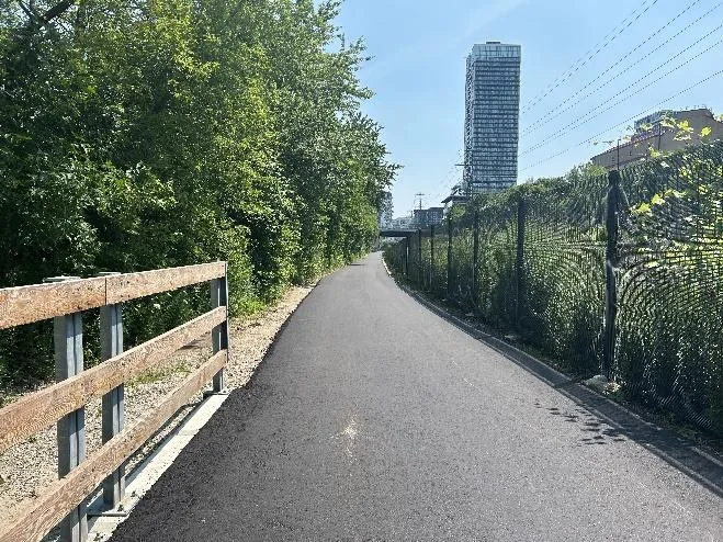 Lower Don Trail with trees and a city building behind it