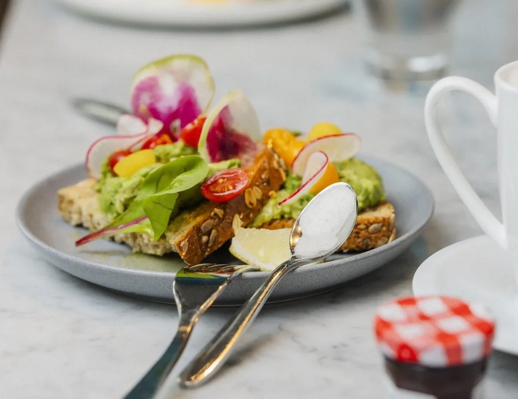 Avocado toast with tomatoes and a cup in an Alt Hotel Toronto Airport food photograph